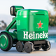 Green Heineken beer cooler robot in front of an in-ground pool
